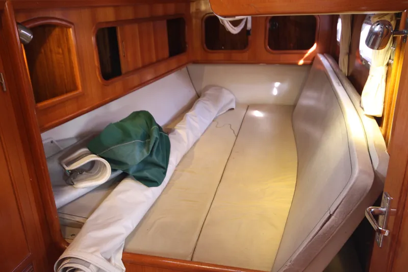 Slide: The Image of Interior cabin of 2001 Outbound 44/46 sailboat with wooden finish and rolled sail. - 27