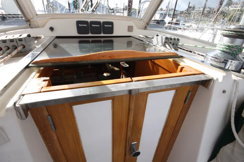 Slide: The Image of Cockpit entrance of 2001 Outbound 44/46 sailboat with wooden doors and winch. - 48