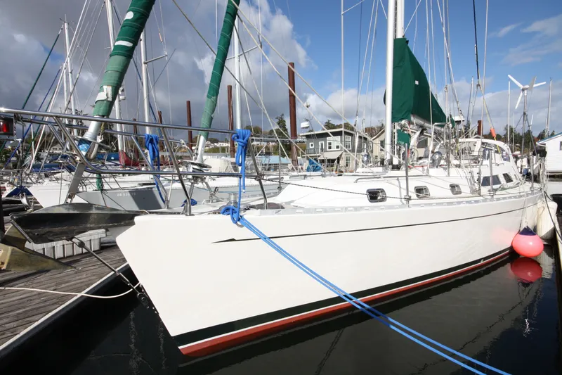 Slide: The Image of Outbound 44/46 sailboat from 2001 docked at a marina under a partly cloudy sky. - 1