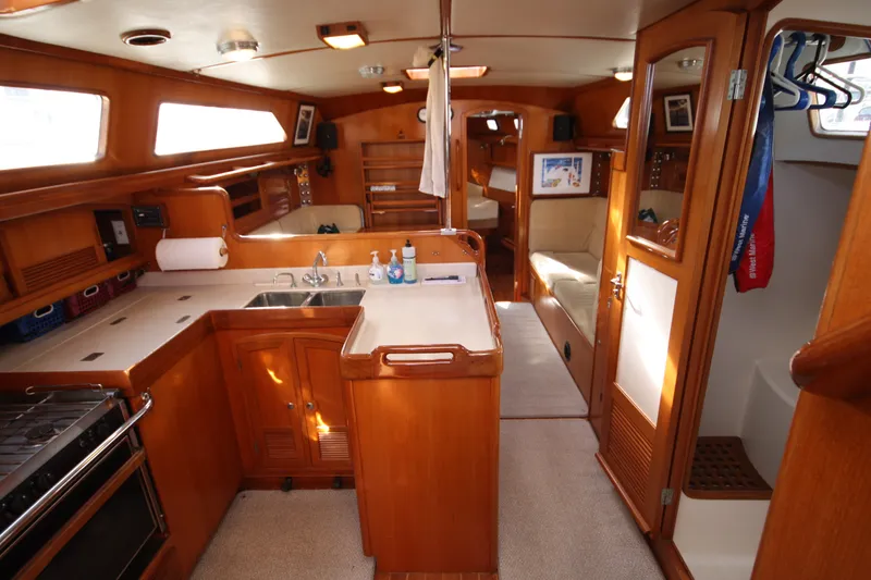 Slide: The Image of Interior of a 2001 Outbound 44/46 sailboat with wooden cabinetry and modern amenities. - 6