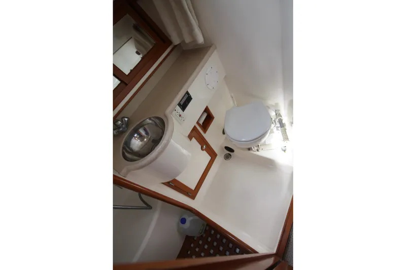 Slide: The Image of Bathroom interior of 2001 Outbound 44/46 yacht, featuring sink and toilet. - 18