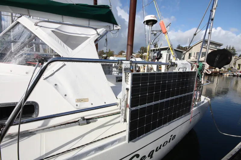 Slide: The Image of Sailboat with solar panels, Outbound 44/46, 2001 model, docked in a marina. - 49