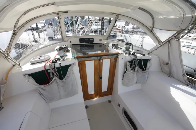 Slide: The Image of Cockpit of 2001 Outbound 44/46 sailboat with seating and storage, docked at marina. - 50