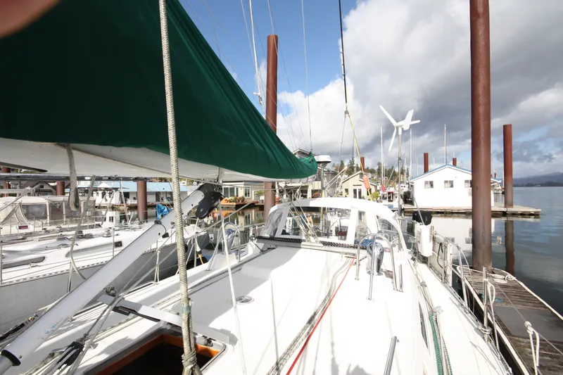 Slide: The Image of Sailboat docked at marina, Outbound 44/46 model, 2001, with green sail cover. - 3