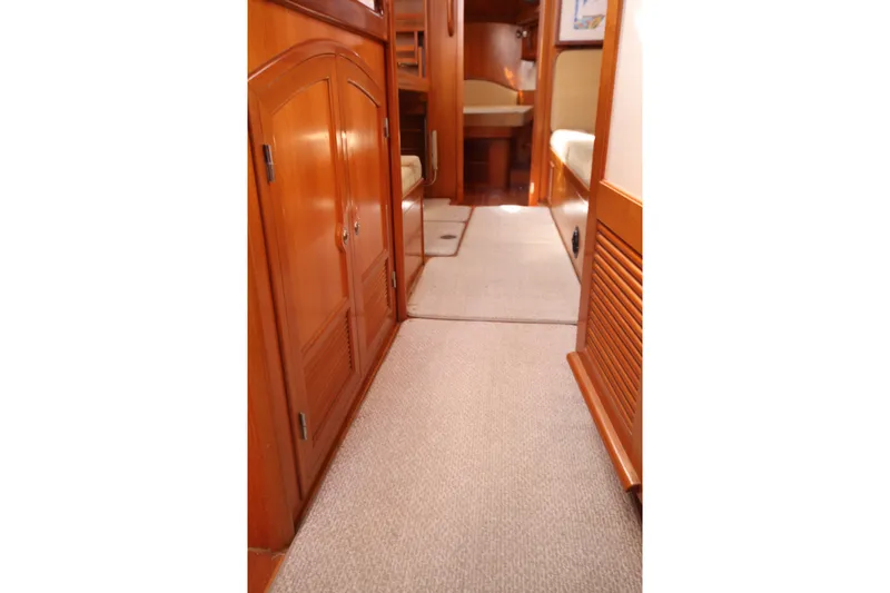 Slide: The Image of Interior view of 2001 Outbound 44/46 yacht, featuring wooden cabinetry and carpeted flooring. - 23