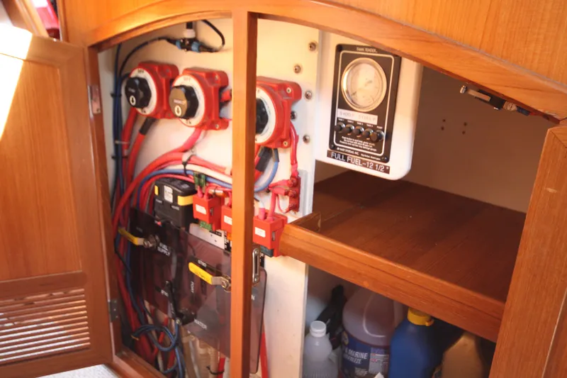 Slide: The Image of Electrical panel inside a 2001 Outbound 44/46 yacht, featuring wiring and gauges. - 24