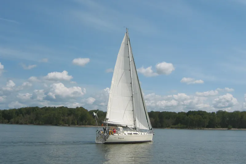 Slide: The Image of Sailboat Outbound 44/46, 2001 model, cruising on a calm lake under a clear sky. - 61
