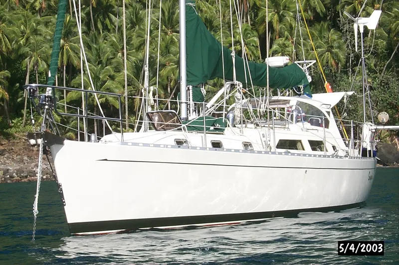 Slide: The Image of Sailing yacht Outbound 44/46, 2001 model, anchored near lush tropical coastline. - 59