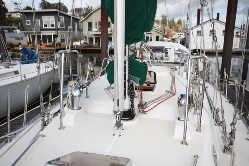 Slide: The Image of Sailboat deck view of 2001 Outbound 44/46, docked near waterfront homes. - 2