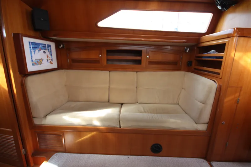 Slide: The Image of Luxurious interior of 2001 Outbound 44/46 yacht with cozy beige seating and wooden cabinetry. - 11