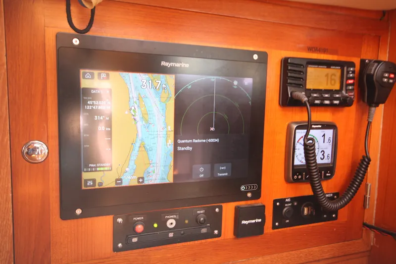 Slide: The Image of Navigation equipment on a 2001 Outbound 44/46 sailboat, featuring Raymarine displays and controls. - 14
