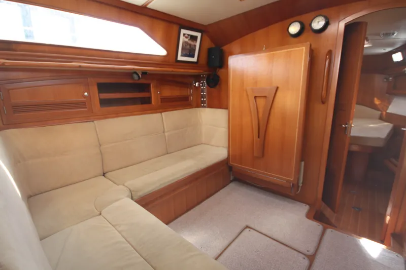 Slide: The Image of Interior of 2001 Outbound 44/46 yacht with wooden cabinetry and beige seating. - 7