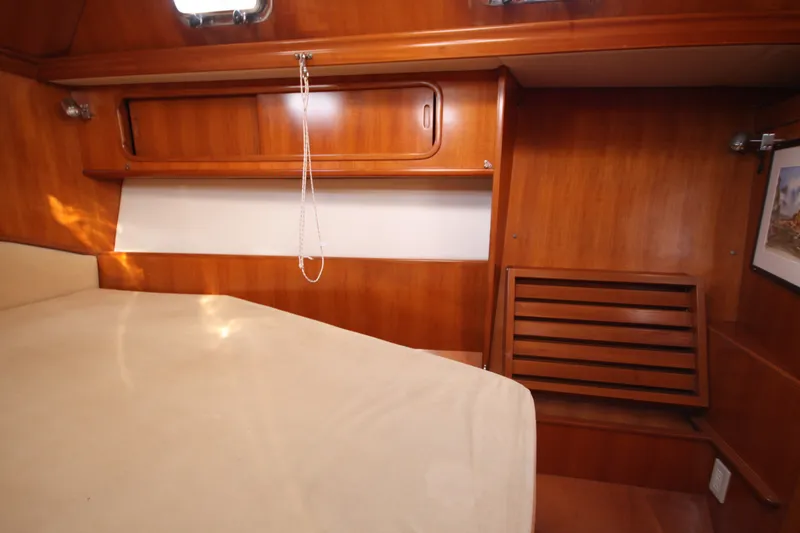 Slide: The Image of Cozy cabin interior of 2001 Outbound 44/46 sailboat with wooden finish and storage. - 21