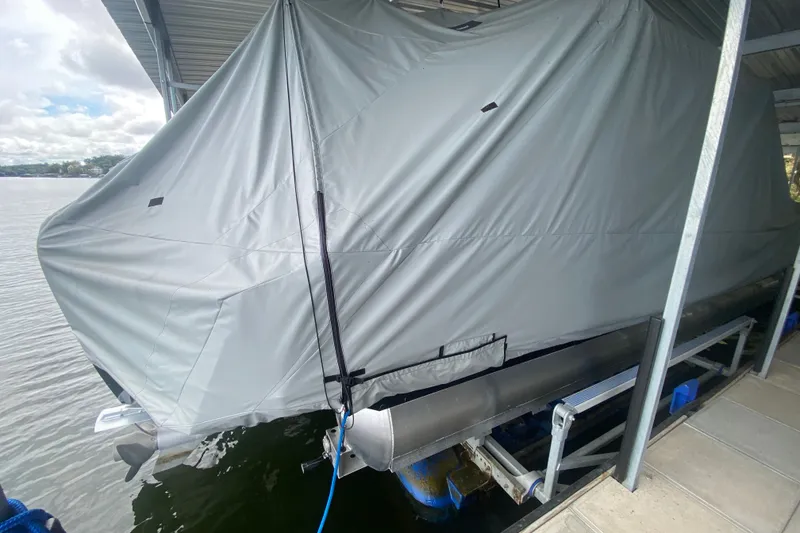 Slide: The Image of Covered 2024 Barletta Corsa 25U pontoon boat docked under shelter. - 30