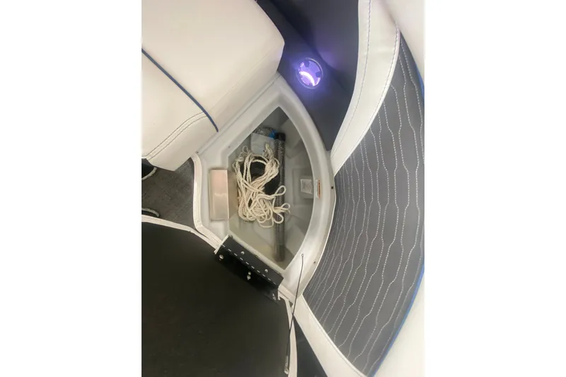 Slide: The Image of 2024 Barletta Corsa 25U boat interior storage compartment with rope and ambient lighting. - 22