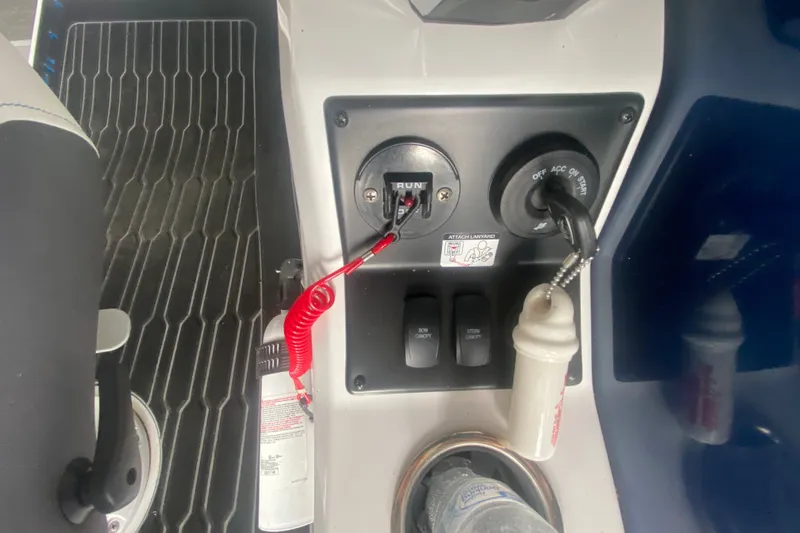Slide: The Image of Control panel of 2024 Barletta Corsa 25U boat with ignition and switches. - 18