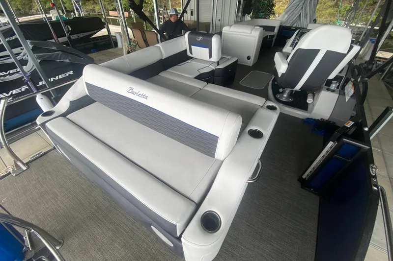 Slide: The Image of 2024 Barletta Corsa 25U pontoon boat interior with plush seating and modern design. - 10