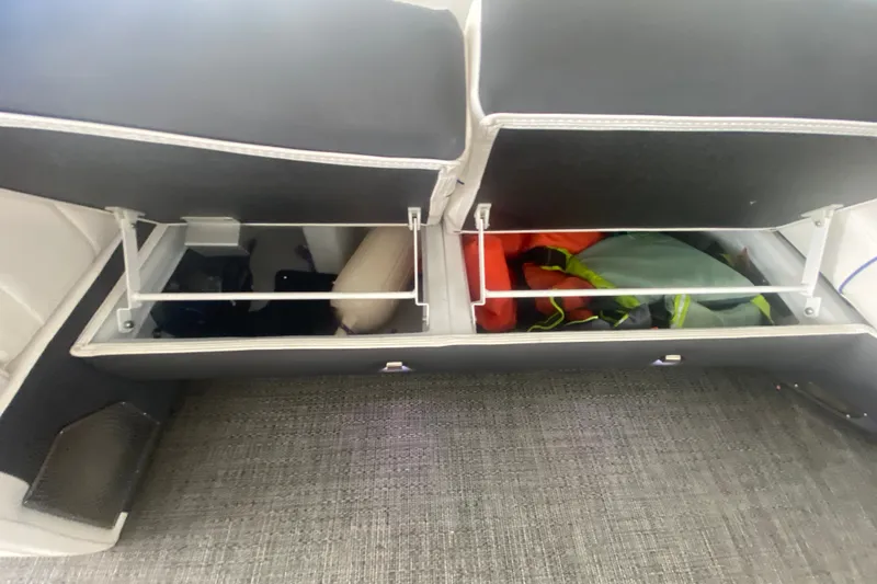 Slide: The Image of 2024 Barletta Corsa 25U boat storage compartments with life jackets and accessories. - 21