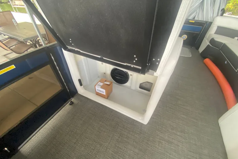 Slide: The Image of 2024 Barletta Corsa 25U interior storage compartment with a small box inside. - 26