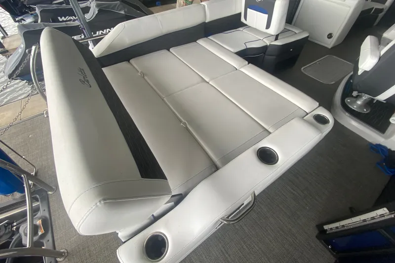 Slide: The Image of 2024 Barletta Corsa 25U boat interior with white seating and cup holders. - 11