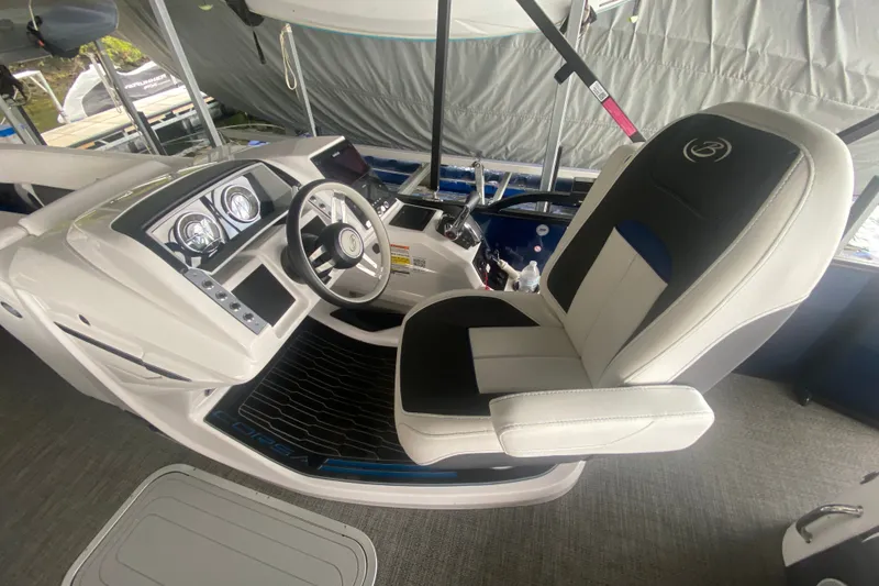 Slide: The Image of 2024 Barletta Corsa 25U boat interior with modern steering and comfortable seating. - 16