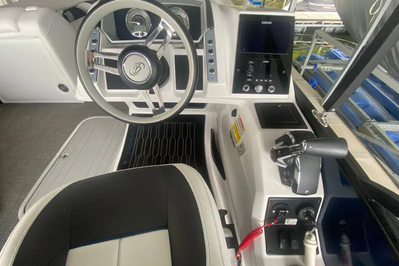 Slide: The Image of 2024 Barletta Corsa 25U boat cockpit with steering wheel and control panel. - 17