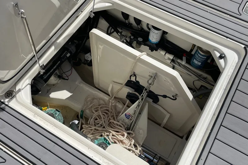 Slide: The Image of Open hatch of 2022 Pursuit OS 355 Offshore boat showing storage and equipment. - 44