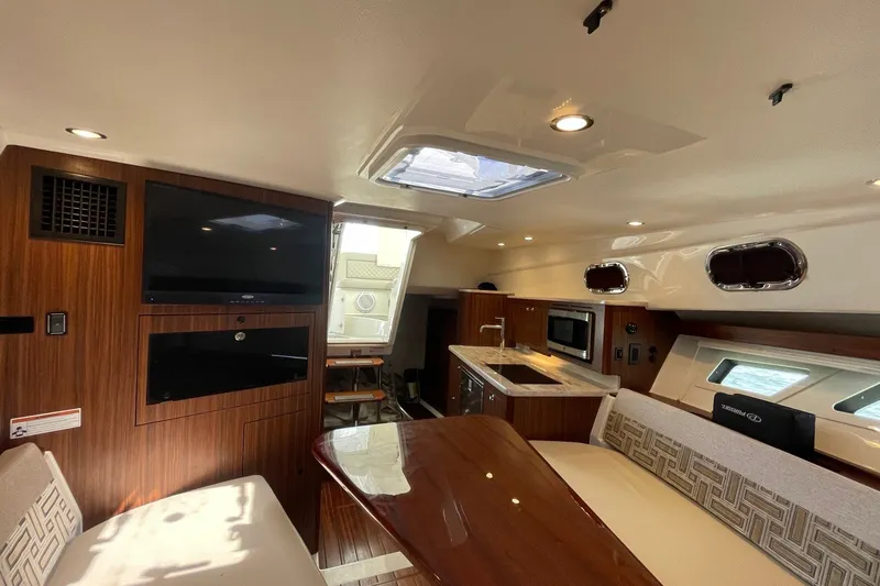 Slide: The Image of Luxurious interior of 2022 Pursuit OS 355 Offshore boat with modern amenities. - 37