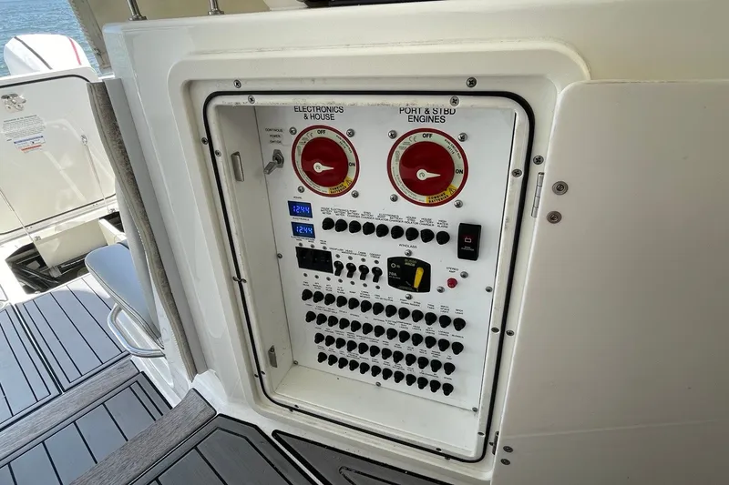 Slide: The Image of Electrical panel on 2022 Pursuit OS 355 Offshore boat, featuring switches and controls. - 41