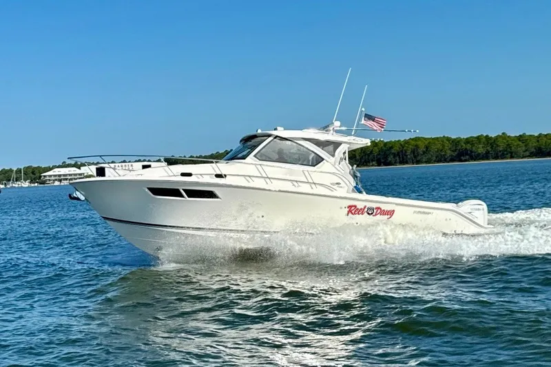 Slide: The Image of 2022 Pursuit OS 355 Offshore boat cruising on a sunny day. - 1