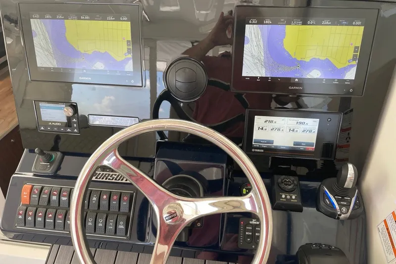 Slide: The Image of Helm of 2022 Pursuit OS 355 Offshore with Garmin displays and Yamaha controls. - 28