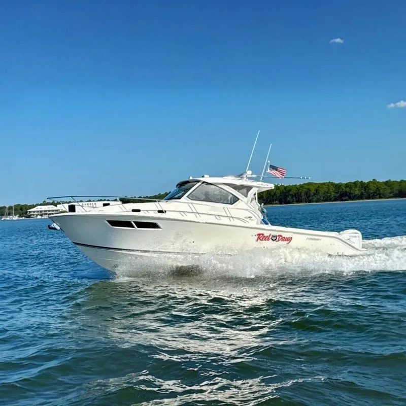 The Image of 2022 Pursuit OS 355 Offshore boat cruising on a sunny day. - 0