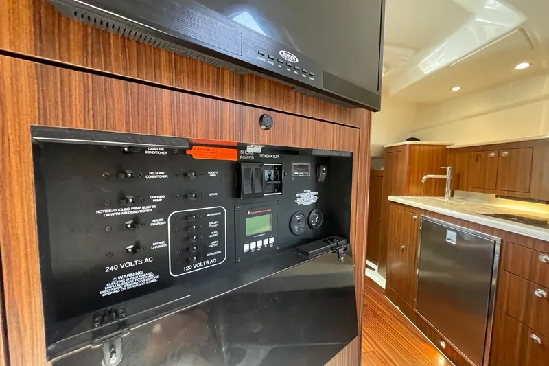 Slide: The Image of 2022 Pursuit OS 355 Offshore yacht interior with control panel and modern kitchen amenities. - 39
