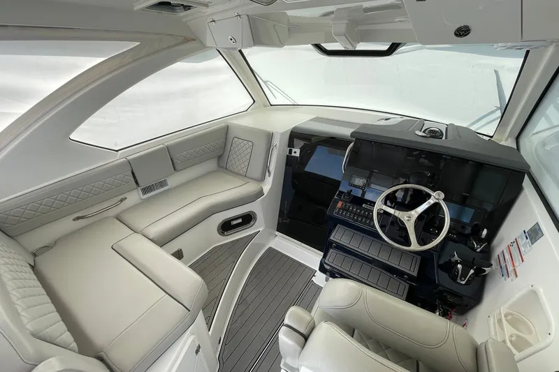 Slide: The Image of Luxurious 2022 Pursuit OS 355 Offshore boat interior with modern helm and seating. - 19