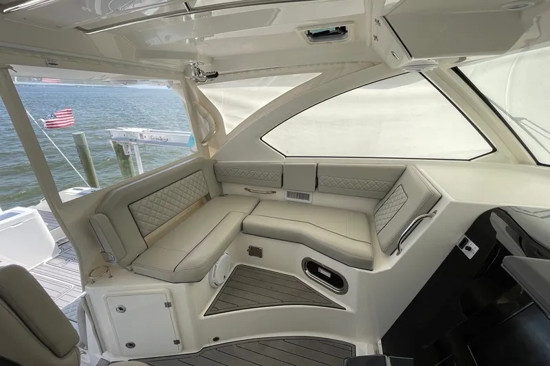 Slide: The Image of 2022 Pursuit OS 355 Offshore boat interior with elegant seating and ocean view. - 20