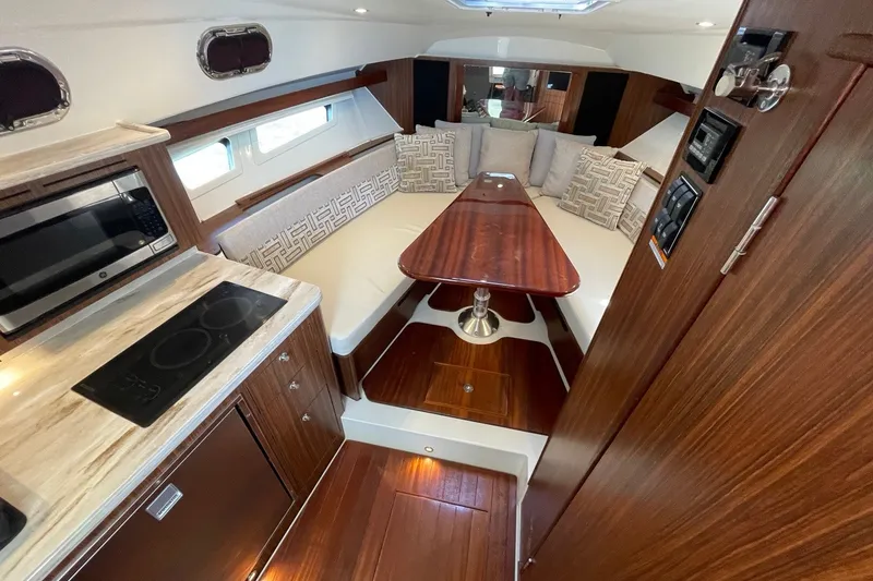 Slide: The Image of Luxurious interior of 2022 Pursuit OS 355 Offshore boat with modern kitchen and seating area. - 34