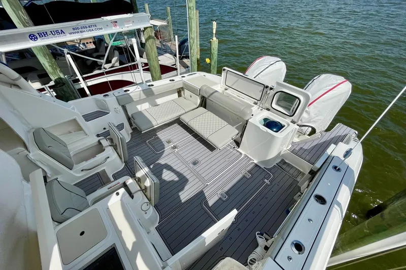 Slide: The Image of 2022 Pursuit OS 355 Offshore boat with spacious deck and seating at marina. - 14