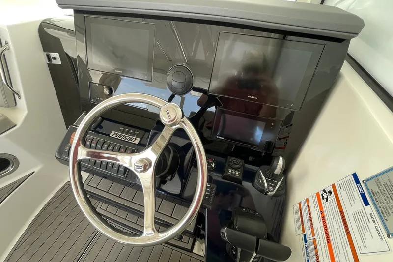 Slide: The Image of Steering console of 2022 Pursuit OS 355 Offshore boat with modern controls and displays. - 27