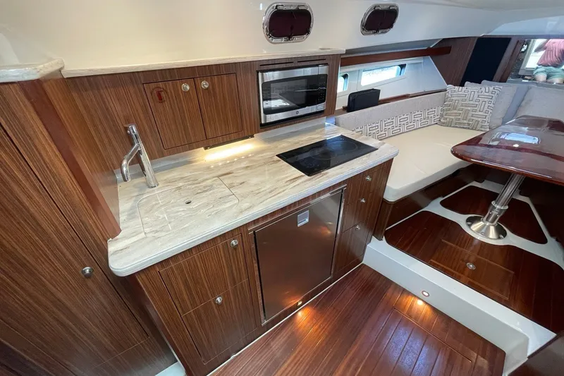 Slide: The Image of Luxurious 2022 Pursuit OS 355 Offshore yacht interior with modern kitchen and seating area. - 33