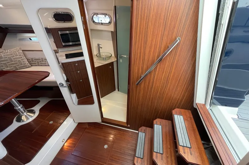 Slide: The Image of Interior of 2022 Pursuit OS 355 Offshore yacht with wood finishes and modern amenities. - 31