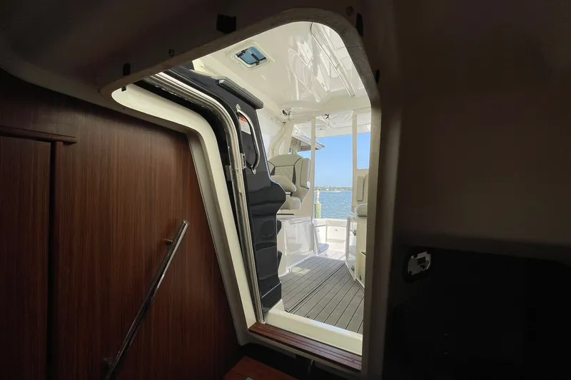 Slide: The Image of Interior view of 2022 Pursuit OS 355 Offshore boat, showing cabin entrance and deck. - 29