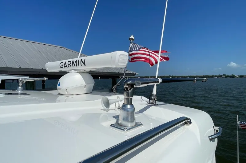 Slide: The Image of 2022 Pursuit OS 355 Offshore boat with Garmin radar and American flag on deck. - 6