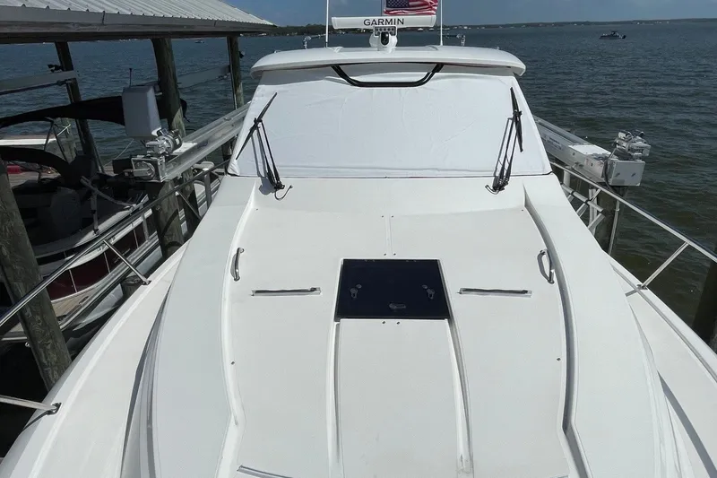 Slide: The Image of 2022 Pursuit OS 355 Offshore boat docked, featuring sleek white deck and Garmin equipment. - 4