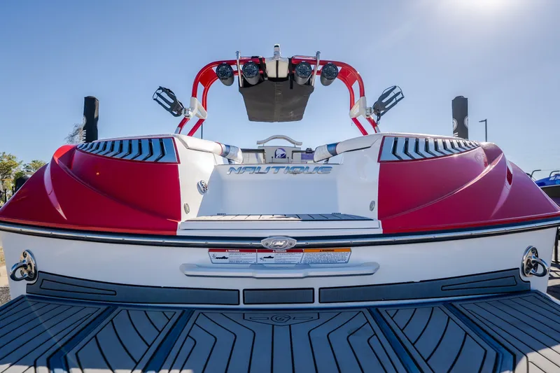 Slide: The Image of 2016 Nautique Super Air Nautique G23 boat, red and white, rear view with wakeboard tower. - 43