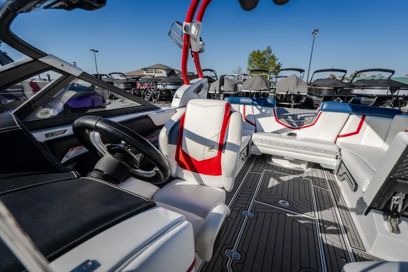 Slide: The Image of Interior of 2016 Nautique Super Air Nautique G23 boat with stylish seating and steering wheel. - 28