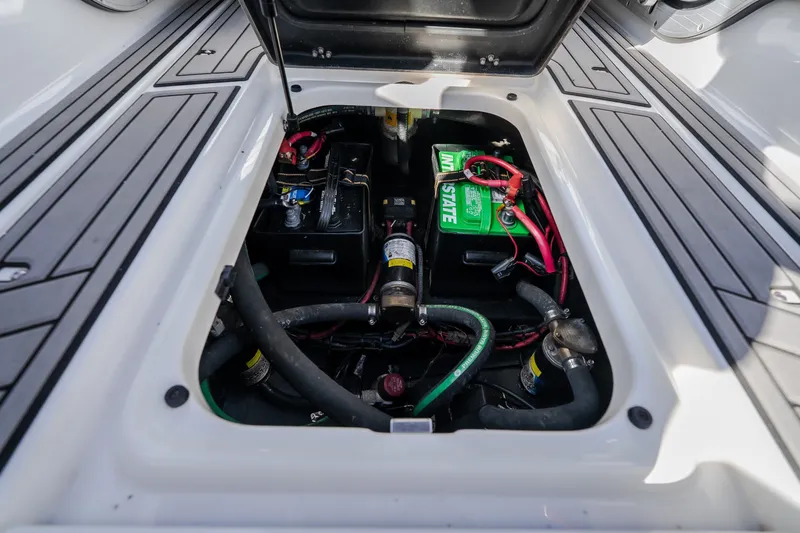 Slide: The Image of 2016 Nautique Super Air Nautique G23 engine compartment with visible battery and wiring. - 30