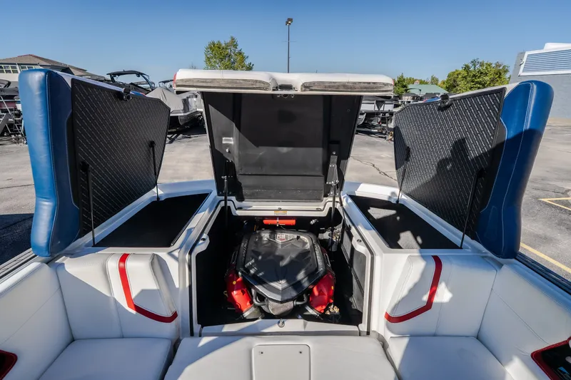 Slide: The Image of 2016 Nautique Super Air Nautique G23 boat engine compartment with open storage hatches. - 34