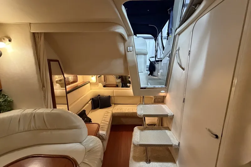 Slide: The Image of Interior of 1999 Sea Ray 340 Sundancer yacht, featuring plush seating and elegant design. - 35