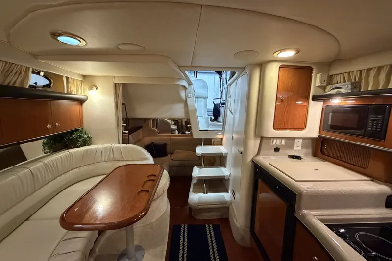 Slide: The Image of Interior of 1999 Sea Ray 340 Sundancer yacht with kitchen and seating area. - 34
