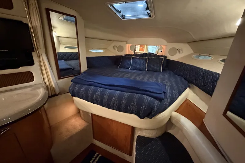 Slide: The Image of Luxurious cabin interior of a 1999 Sea Ray 340 Sundancer yacht with cozy bedding. - 28